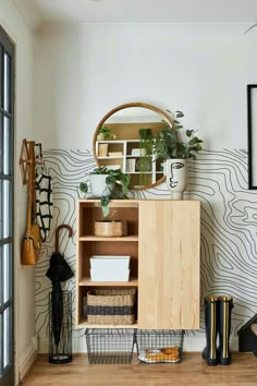 a room with a wooden cabinet, mirror and other items on the wall next to it