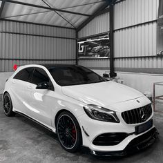 a white mercedes cla parked in a garage