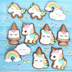 cookies decorated like unicorns and rainbows on a blue background