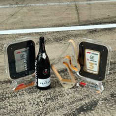 a bottle of beer sitting on the ground next to other items