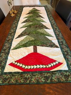 a quilted table runner with a christmas tree on it