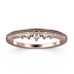 a rose gold wedding ring with diamonds on the side and an arrow design in the middle