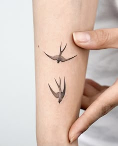 two birds tattoo on the left arm