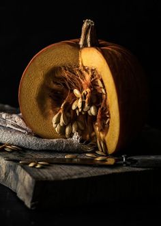 a close up of a pumpkin with seeds on it next to a pair of scissors