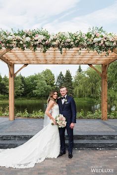 a bride and groom pose for a wedding photo