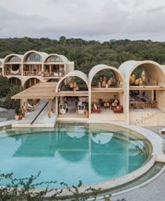 an outdoor swimming pool surrounded by wooden structures