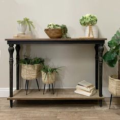 some plants are sitting on top of a shelf