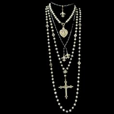 The Moonglow Sacred Heart Cross Rosary Necklace is designed as a true five decade rosary. It is 30" inches long and comes with a 4" complimentary enhancer that allows the necklace to be double. It features 9mm Silver Freshwater Pearls, mini Fleur de Lis and a reproduction French Sacred Heart Cross. The cross is two sided with the Sacred Heart on one side and a Lily at the center of the reverse. Length: 30" Gemstones: Silver Fresh Water Pearls Metal: Sterling Silver Clad Bronze Freshwater Pearls Jewelry, Long Layered Pearl Necklace, Pearl Necklace Silver Chain, Long Cross Necklace, Pearl Necklace Long, Silver Long Necklace, Pearl Cross Necklace, Multiple Necklaces, Heart Cross Necklace