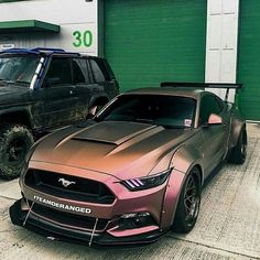 two cars parked next to each other in front of a garage