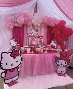 a hello kitty birthday party with balloons and decorations