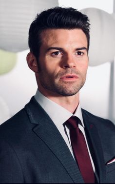 a man in a suit and tie posing for a photo