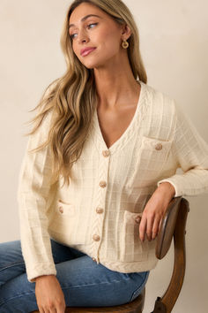 Stay ahead of the fashion game with our Quiet Days Ivory Cable Knit Cardigan. This stylish and versatile sweater is the perfect addition to your wardrobe, allowing you to effortlessly elevate any outfit. With its soft and cozy fabric, you'll feel confident and comfortable all day long. Don't miss out on this must-have piece! This ivory cardigan features a v-neckline, a functional button front with gold buttons, a cable knit grid design, functional pockets, braided knit hems, and long sleeves. Elegant Cream Textured Knit Outerwear, Cream Knit Outerwear For Loungewear, Chic Cream Sweater For Fall, Elegant Cream Sweater For Fall, Chic Soft Texture Cardigan For Loungewear, Chic Soft Knit Cardigan For Loungewear, Chic Soft Knit Loungewear Cardigan, Chic Knit Cardigan With Soft Texture, Beige Sweater With Soft Texture For Spring