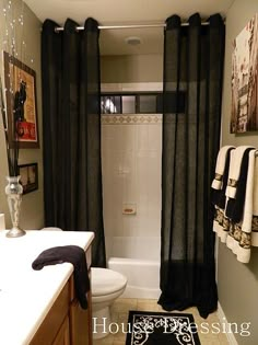 an image of a bathroom setting with pictures on the wall