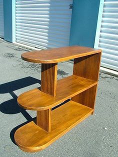 a wooden shelf sitting on the side of a road