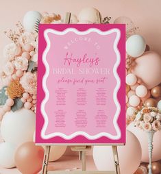 a pink and white bridal shower sign in front of balloons, flowers and other decorations