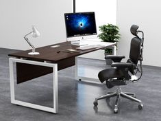 an office desk with a computer on it and a chair in front of the desk