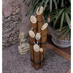 a group of vases sitting on top of each other in front of a plant