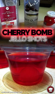 cherry bomb jello shots in a plastic bowl on a table with the words cherry bomb jello shots