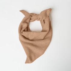 Fine knit bandana scarf made from 100% italian eco cashmere in camel.  measures approximately 20" (50 cm) along the straight edge.  this item is final sale!  content: 100% italian eco cashmere.  easy care instructions:  - wash in warm water with cashmere or wool shampoo. lay flat to dry.  - for easy care dry cleaning recommended.  made in a family-owned factory in romania.  a sustainable wardrobe starts with buying less and using longer. we want to ensure you love your purchase and wear it for seasons to come. Knit Bandana, Sustainable Wardrobe, Layering Jacket, Smokey Topaz, Knit Alpaca, Triangle Scarf, Bandana Scarf, Favorite Daughter, Mohair Wool