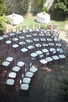 rows of chairs are arranged in the shape of a circle for an outdoor wedding ceremony