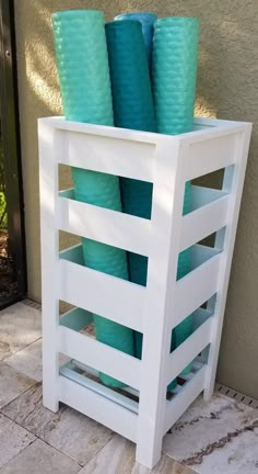 a stack of blue cups sitting on top of a white shelf next to a door