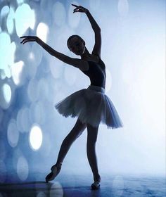 a young ballerina is posing for the camera