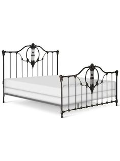 a bed with metal frame and white sheets