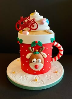 a christmas themed coffee cup cake on a plate