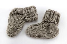 two knitted mittens sitting on top of each other