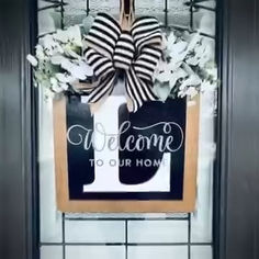 a welcome sign hanging on the front door