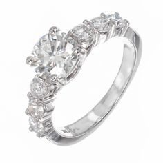 a diamond ring with three stones on the side