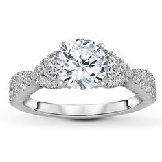 a white gold engagement ring with diamonds on it