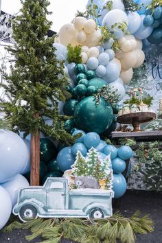 a truck is parked in front of balloons and trees