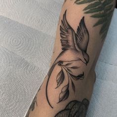 a black and white bird tattoo on the leg