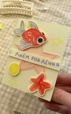 a hand holding up a card with fish and stars on the side that says, i amen poka - ahna