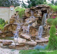 a large waterfall in the middle of a garden