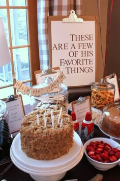 a table topped with lots of food and desserts next to a sign that says these are a few of his favorite things