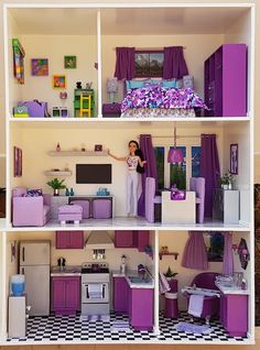 a doll house with purple furniture and accessories