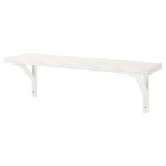 a white shelf sitting on top of a wall