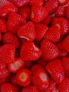 a pile of red strawberries sitting on top of each other