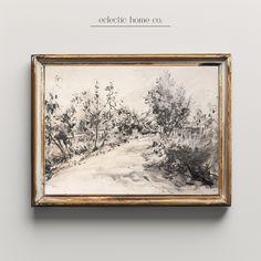 a painting hanging on the wall in front of a white wall with a wooden frame