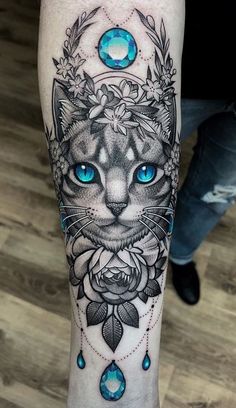 a black and white cat with blue eyes on the leg