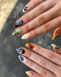 The nails display a colorful array of autumn-inspired shades with simple floral accents, ideal for the fall season.  🍂 Recreate this look yourself with our Korean Gel Nail Polish collection!  🍂 Credit: thehumbleroom_ on Instagram 🍂 almond nails, colorful nails, gel nails, brown nails, orange nails, yellow nails, green nails, blooming gel nails, floral nails, blooming nails, fall nails, autumn nails, september nails, summer to fall transition nails, fall nail designs, summer to fall transition nails, fall nail colors, Korean gel polish, nail trends, nail art, seasonal nails, elegant nails, nail polish, autumn colors, floral patterns, manicure ideas, gel nails, Instagram nails Almond Nails Colorful, Gel Nails Floral, Fall Gel Nail Colors, Summer To Fall Transition Nails, Biab Manicure, Almond Fall Nails, Blooming Gel Nails, Blooming Gel, September Nails