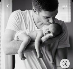 a man holding a baby in his arms