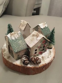 a small house on a log with pine cones