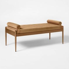 a wooden bench with two pillows on it's backrests and an arm rest