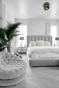 a bedroom with white walls and carpeted flooring has a round bed in the center