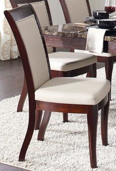 a dining room table and chairs with white rugs