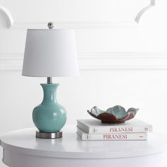 Bring a burst of color to any room with this contemporary blue table lamp. Its genie-style design features soft curves, while its chic nickel base and matching finial create its clean, modern style. Designers love its complementary crisp cotton shade. Care Instructions: Before cleaning any lamp shade or fixture, disconnect the power source. Wipe with a soft, dry cloth. Avoid the use of chemicals and household cleaners as they may damage the finish. Blue Shades Colors, Blue Table Lamp, Unique Lamp, Blue Table, Led Table Lamp, Clean Modern, Table Lamp Lighting, Modern Elegance, Light Shades