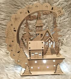 a wooden clock with a house on it